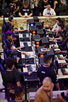 Players engaged in an intense e-sports competition, focused on screens.