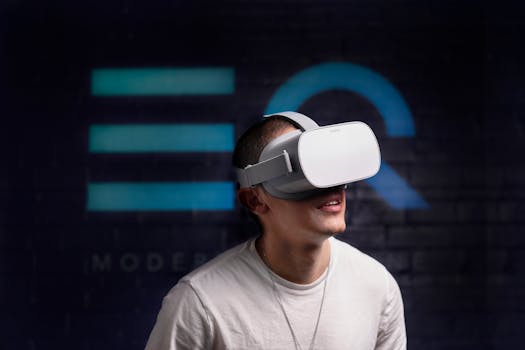 Young man wearing VR headset, exploring virtual reality indoors with a smiling expression.